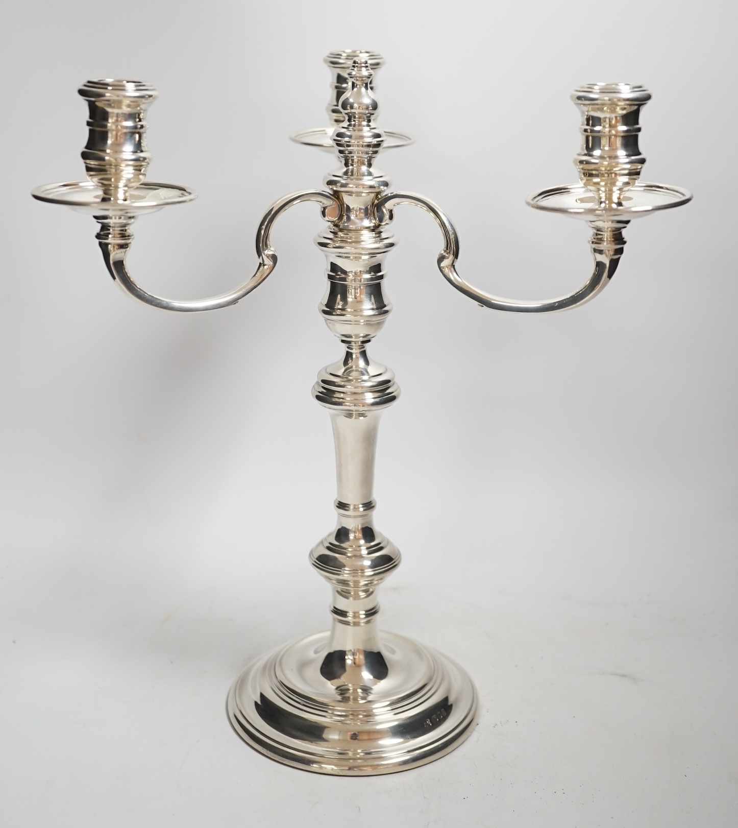 An Elizabeth II silver three branch, three light candelabrum, by William Comyns & Sons Ltd, London, 1965, height 34cm, weighable silver 16oz.